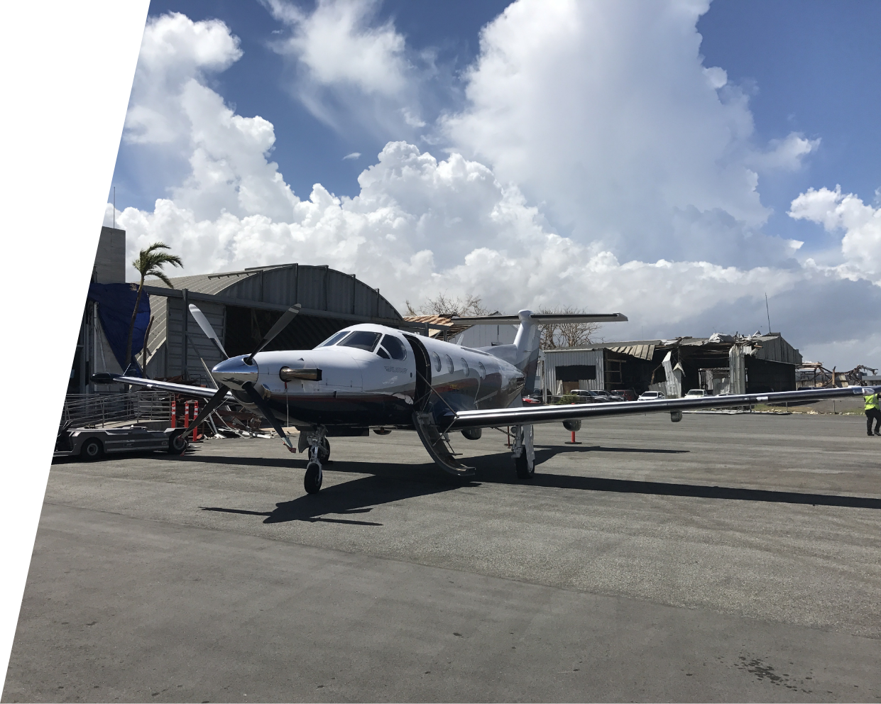 Pilatus PC12 airplane in front of hangars on a Caribbean disaster relief mission.